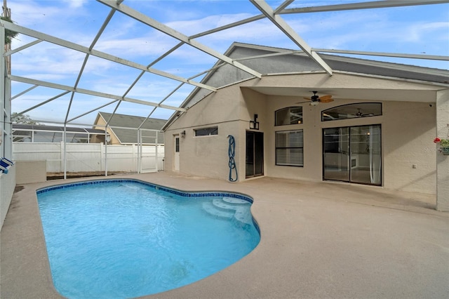 view of swimming pool featuring a patio area, a lanai, and ceiling fan