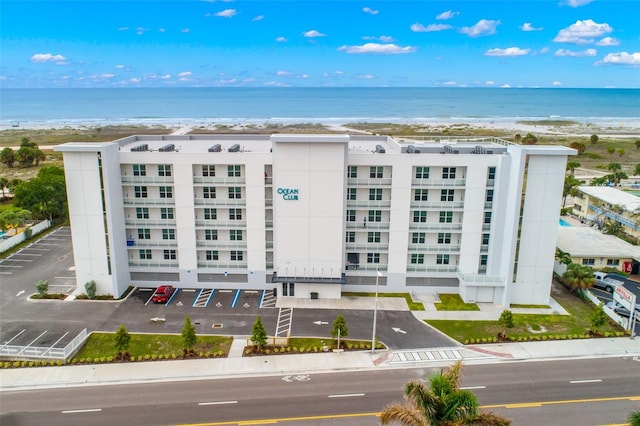 view of property featuring a water view and a beach view