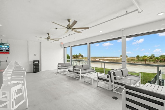 sunroom featuring ceiling fan