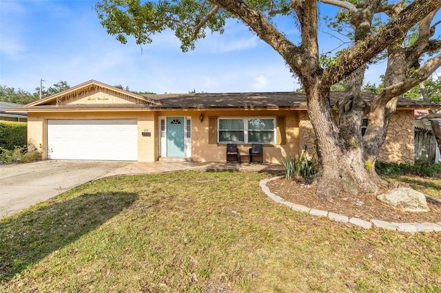 ranch-style home with a garage and a front yard