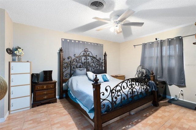 bedroom featuring ceiling fan, a textured ceiling, and light tile patterned floors