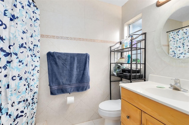 bathroom with tile walls, walk in shower, and vanity