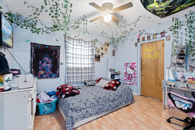 bedroom featuring a textured ceiling, ceiling fan, and hardwood / wood-style flooring