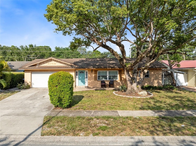 ranch-style house featuring a garage and a front lawn