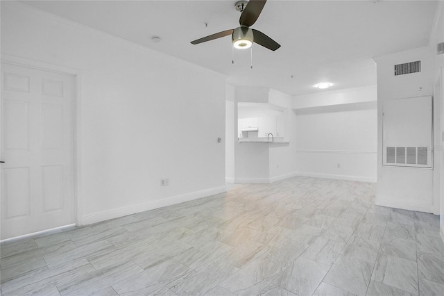 unfurnished room with ceiling fan and crown molding