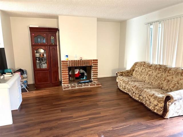 living room with a textured ceiling, dark wood-type flooring, and a fireplace