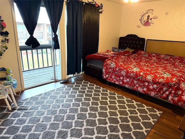 bedroom featuring hardwood / wood-style flooring and access to outside