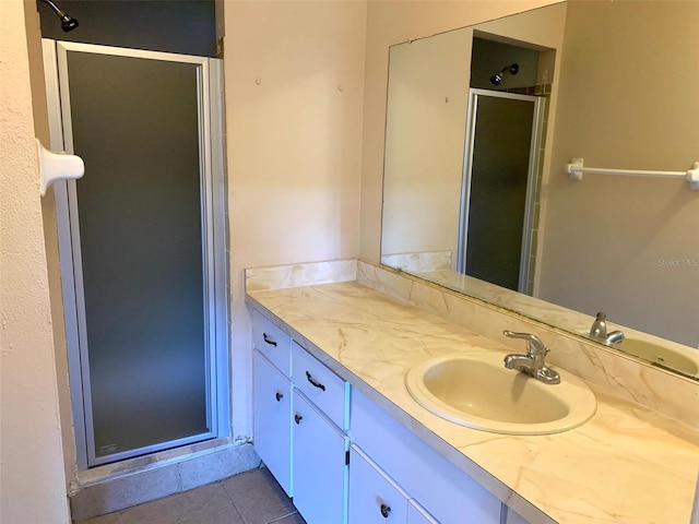 bathroom with vanity, tile patterned flooring, and a shower with door