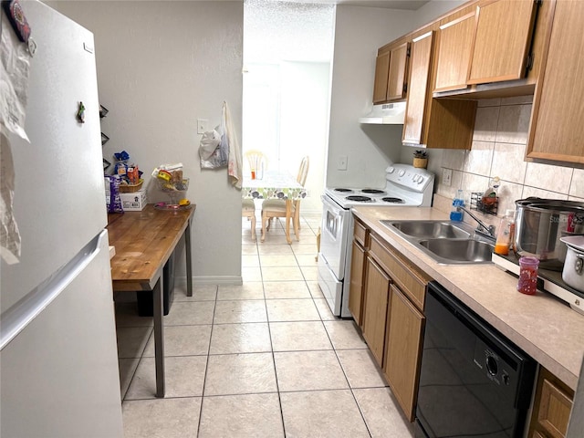 kitchen with white appliances, a textured ceiling, decorative backsplash, sink, and light tile patterned floors