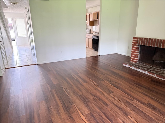 5123 Picadilly Circus Ct Unit 2, Orlando, FL 32839 - unfurnished living room featuring wood finished floors, baseboards, a brick fireplace, and a sink