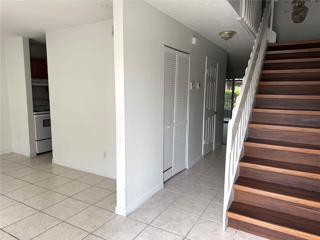 5123 Picadilly Circus Ct Unit 2, Orlando, FL 32839 - stairs with tile patterned flooring, a textured ceiling, and baseboards