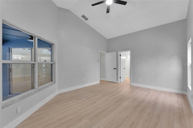 unfurnished room featuring ceiling fan, high vaulted ceiling, visible vents, baseboards, and light wood-type flooring