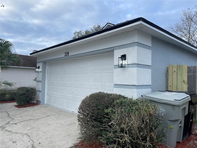 view of side of property featuring driveway and stucco siding