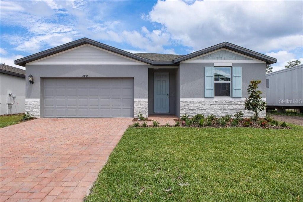 view of front of house with a front yard and a garage