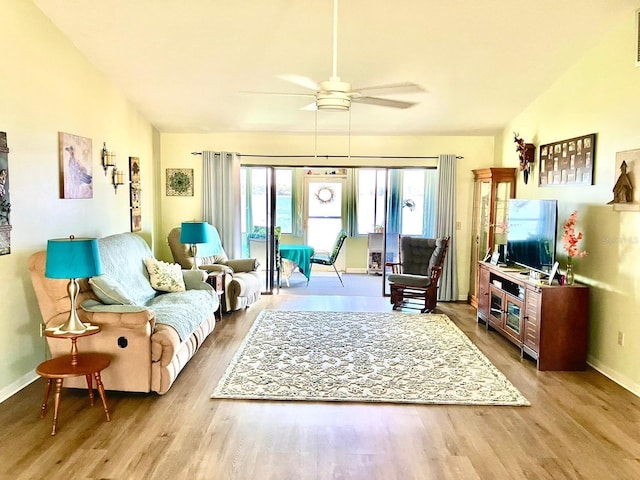 living room with hardwood / wood-style floors and ceiling fan