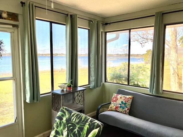 sunroom featuring a water view and a wealth of natural light