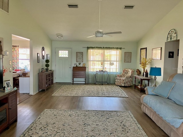 living room with hardwood / wood-style floors, vaulted ceiling, and ceiling fan