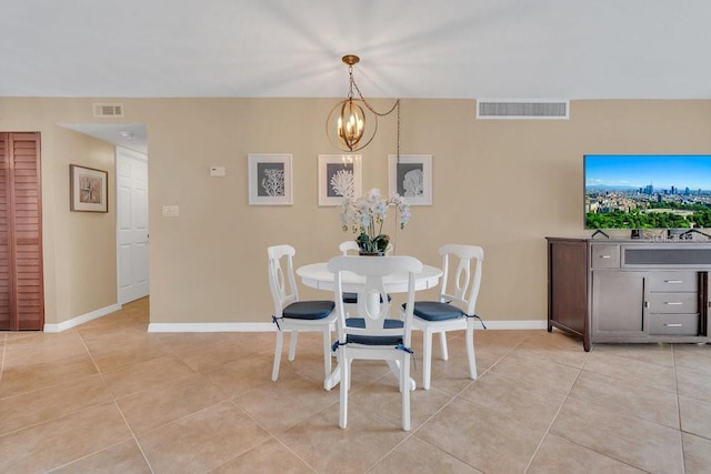 dining area featuring light tile patterned floors and a chandelier