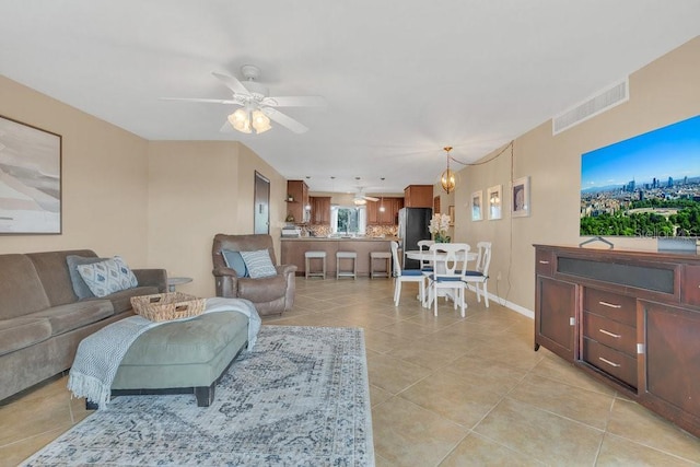 living room featuring ceiling fan and light tile patterned floors