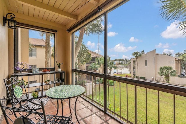 sunroom with wood ceiling and beamed ceiling