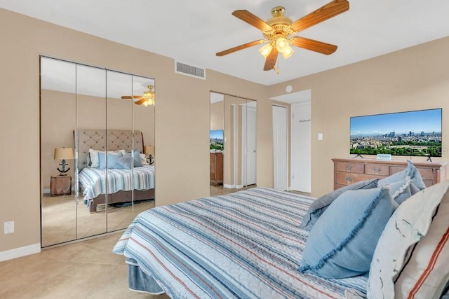 bedroom featuring ceiling fan and two closets