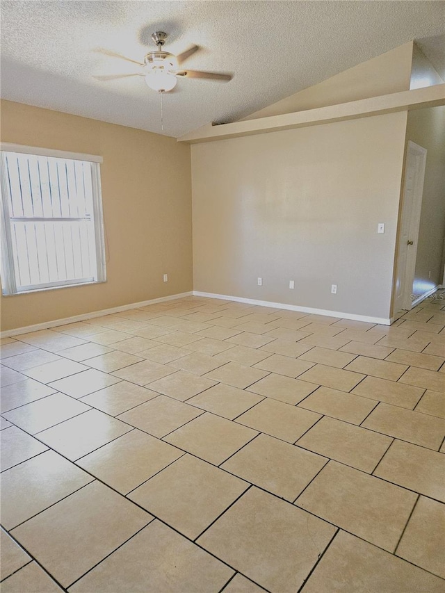 unfurnished room featuring ceiling fan, a textured ceiling, light tile patterned floors, and vaulted ceiling