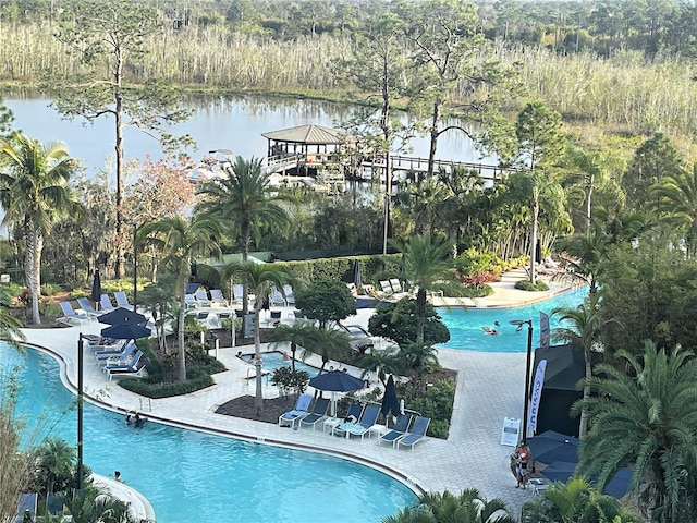 view of swimming pool with a gazebo and a water view