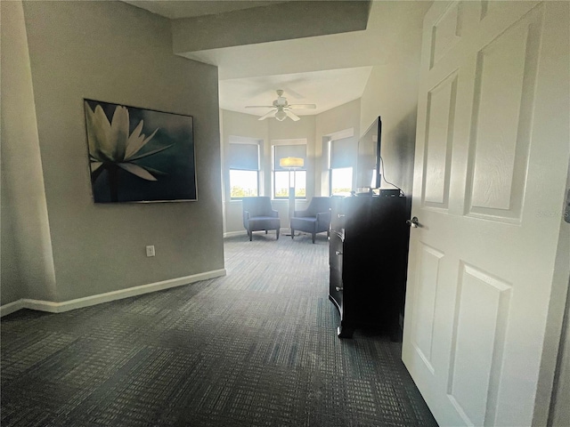 hallway featuring dark colored carpet