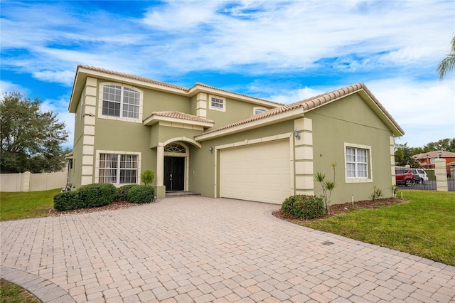 mediterranean / spanish house with a garage and a front yard