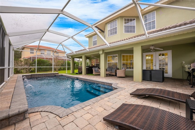 view of pool featuring ceiling fan, outdoor lounge area, pool water feature, french doors, and a patio