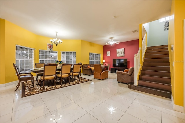 dining room with ceiling fan with notable chandelier