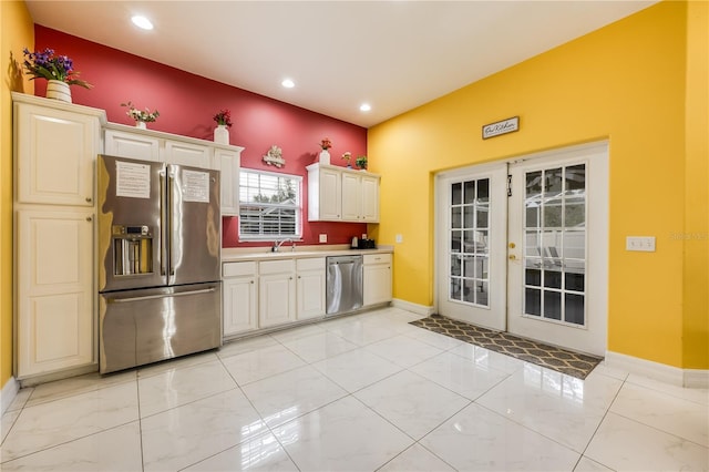 kitchen with stainless steel appliances, french doors, and sink