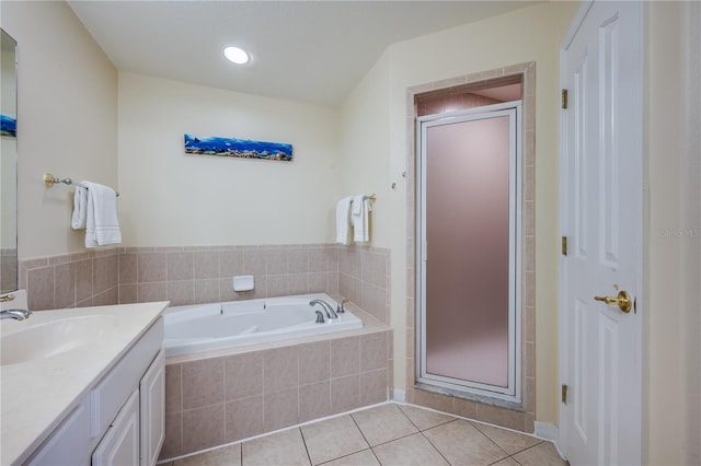 bathroom with vanity, tile patterned floors, and shower with separate bathtub