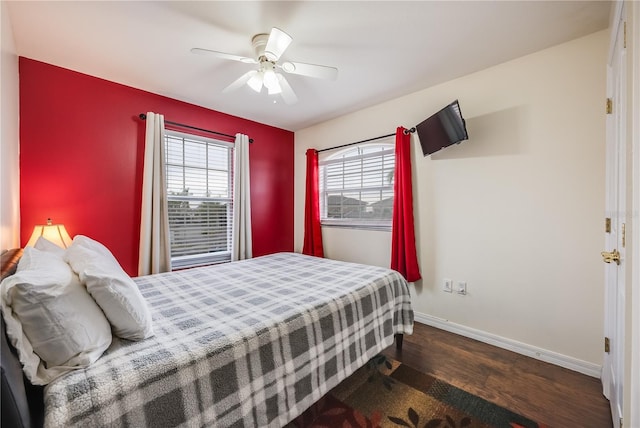 bedroom with ceiling fan and dark hardwood / wood-style floors