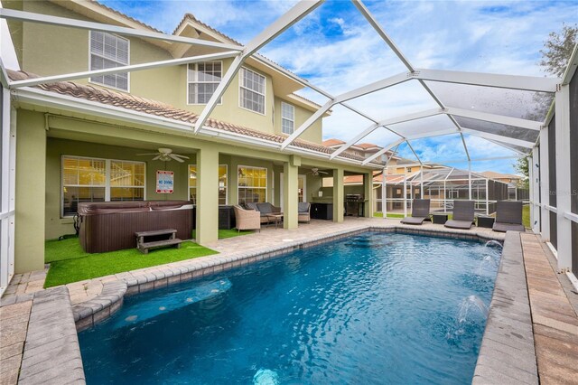 view of swimming pool featuring ceiling fan, pool water feature, a hot tub, an outdoor hangout area, and a patio