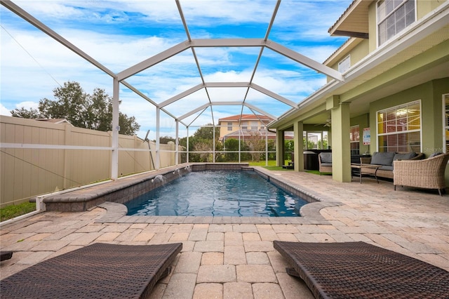 view of swimming pool featuring a patio area, a lanai, pool water feature, and an outdoor hangout area