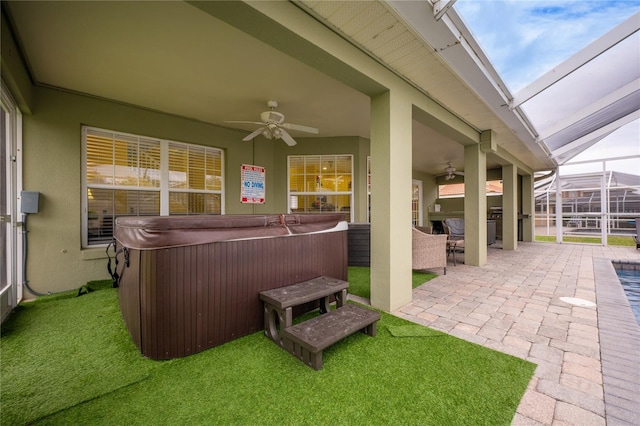 view of patio with ceiling fan and a hot tub