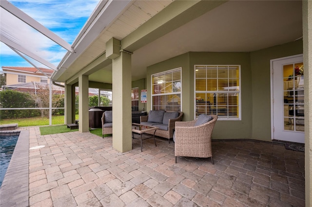 view of patio / terrace featuring outdoor lounge area and glass enclosure