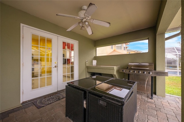 view of patio with ceiling fan, a lanai, and french doors