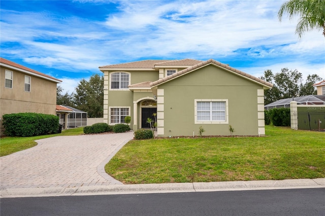 mediterranean / spanish house featuring a front lawn