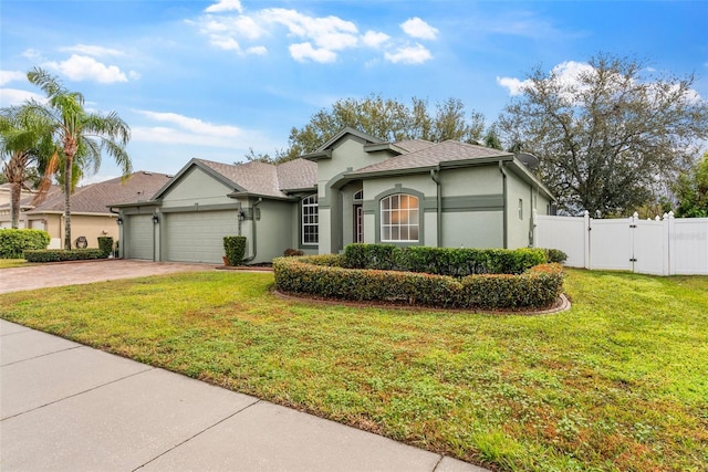 view of front of property featuring a garage and a front lawn