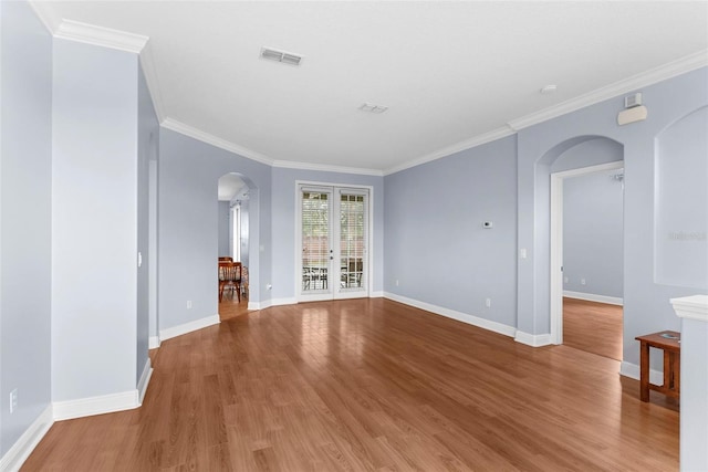 empty room featuring hardwood / wood-style floors and ornamental molding