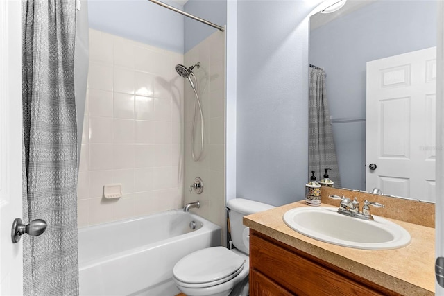 full bathroom featuring toilet, shower / tub combo with curtain, and vanity