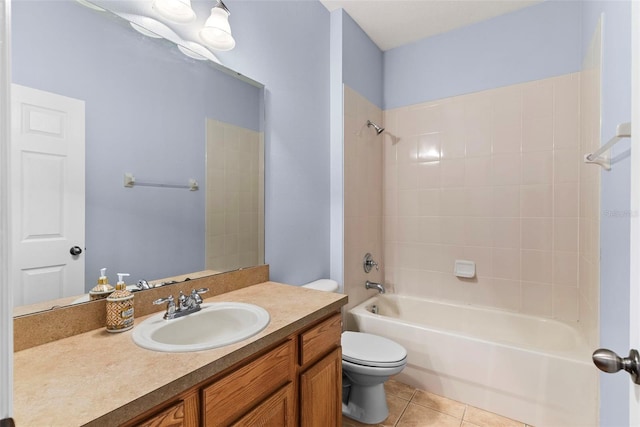 full bathroom featuring tile patterned floors, toilet, vanity, and tiled shower / bath