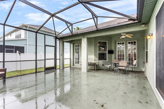 view of patio with ceiling fan and a lanai