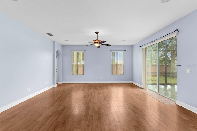 spare room with hardwood / wood-style floors, plenty of natural light, and ceiling fan