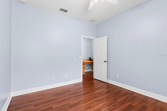 spare room featuring ceiling fan and dark hardwood / wood-style flooring