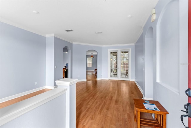 hall with hardwood / wood-style flooring and crown molding