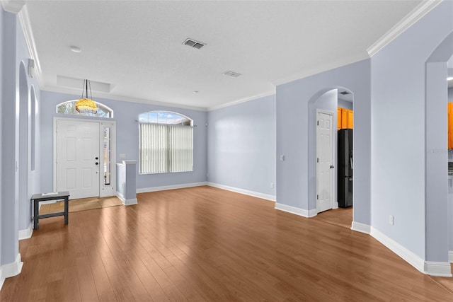 entryway featuring hardwood / wood-style flooring and ornamental molding