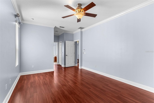 empty room featuring ceiling fan, dark wood-type flooring, and crown molding